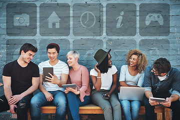 Image showing Technology, diversity and group of young people on a bench browsing social media or the internet. Digital tablets, laptop and multiracial friends networking online together with icons by a gray wall.