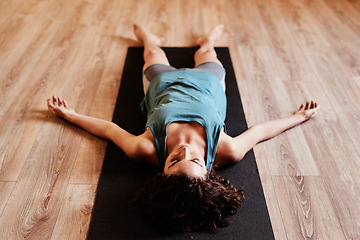 Image showing Woman, yoga and sleeping on floor for rest, peace and mindfulness in gym, fitness studio or class. Girl, meditation and relax for wellness, training and zen mindset for faith, balance or self care