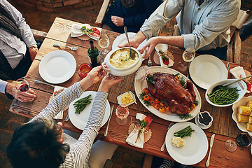 Image showing Food, table and family eating together for holiday celebration or dinner party with health vegetables. Above group of people or friends hands sharing lunch meal, chicken or turkey with wine drinks