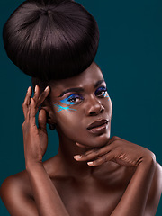 Image showing Portrait, hair and cosmetics with an african woman in studio on a blue background for beauty or makeup. Eyeshadow, haircare and fashion with an attractive young female model at the salon for style