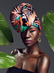 Image showing Black woman in portrait in African turban, leaves and fashion with makeup and beauty on studio background. Natural cosmetics, nature aesthetic and female model on traditional head wrap with style