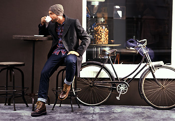 Image showing Relax, cafe and man with a coffee, bike and fashion in the city, sustainable and carbon footprint. Male person, guy and biker with tea, street and outdoor with bicycle and eco friendly transport