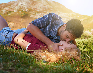 Image showing Relax, kiss and love with couple in nature for carefree, bonding and affectionate. Happiness, date and romance with man and woman cuddling in grass field for summer break, happy and relationship