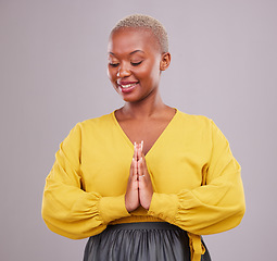 Image showing Hands together, smile and black woman with prayer, hope and religious belief against a grey studio background. Female person, worship and model with hand gesture, happiness and faith with wellness