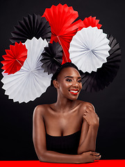 Image showing Smile, thinking and black woman with origami fans, beauty and confident lady against a black background. Female person, model and girl with paper art, creativity and glamour with ideas and fantasy