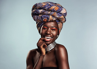 Image showing Happy black woman in African turban, fashion and beauty with makeup isolated on studio background. Natural cosmetics, smile in portrait and female model in traditional head wrap, playful and style