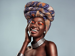 Image showing Head scarf, black woman laugh and portrait with African beauty and makeup in a studio. Isolated, grey background and traditional fashion with a female model pride with culture cosmetics and jewelry