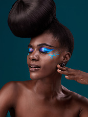 Image showing Face, makeup and hair with an african woman model in studio on a blue background for cosmetics or haircare. Beauty, eyeshadow and haircare with an attractive young female person posing eyes closed