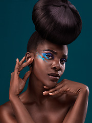 Image showing Portrait, beauty and hair with an african woman in studio on a blue background for makeup or cosmetics. Face, haircare and fashion with an attractive young female model at the salon for trendy style