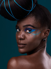 Image showing Portrait, hair and rear view with a model black woman in studio on a blue background for beauty. Face, fashion and makeup with an attractive young female person looking over her shoulder at the salon