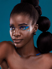 Image showing Thinking, makeup and hair care with an african woman in studio on a blue background for hairstyle or cosmetics. Face, idea and fashion with an attractive young female model posing for beauty or style