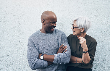 Image showing Senior, creative and professional with wall in white background talk about collaboration for business. Employee, conversation and outdoor about teamwork with smile for working on startup as career.