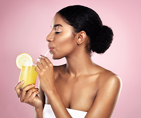 Image showing Woman, orange juice drink and glass in studio, pink background or detox for healthy weight loss. African model, citrus smoothie and vitamin c fruits for nutrition benefits, natural beauty or wellness