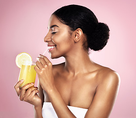 Image showing Happy woman, healthy orange juice and glass in studio, pink background and detox for weight loss. African model, citrus smoothie and vitamin c fruits for vegan nutrition, diet drink or natural beauty