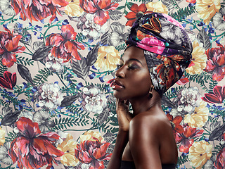 Image showing Black woman in turban, fashion on flower background and beauty, makeup with floral aesthetic. Natural cosmetics, profile and female model in traditional African head wrap with creativity and style