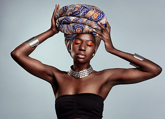 Image showing African fashion, makeup and black woman in studio on white background with luxury, cosmetics and beauty. Glamour, luxury and face of female person glow in exotic jewelry, traditional style and scarf