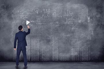 Image showing Businessman, numbers and chalkboard for finance in background is thinking of investment with graph. Professional person, planning and writing about future of company with idea to invest for profit.