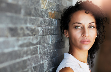 Image showing Portrait, serious and woman against a brick wall, thinking and focus with thoughts, future and informal. Face, female person and confident girl with assertive look, casual outfit and attractive lady