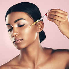 Image showing Face, skincare serum and woman with eyes closed in studio isolated on a pink background. Dermatology, cosmetics and Indian model with hyaluronic acid, essential oil or vitamin a for healthy skin.