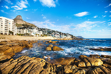 Image showing City, travel and view of rocky ocean for natural environment, ecosystem and seascape background. Traveling mockup, location and sea in South Africa for holiday, summer vacation and global destination