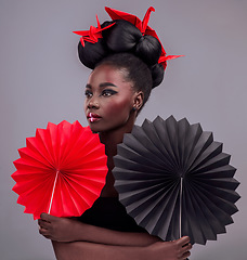 Image showing Beauty, cosmetics and origami with black woman in studio for creative, art and culture. Traditional, makeup and paper design with female model and fans on grey background for asian, retro or color