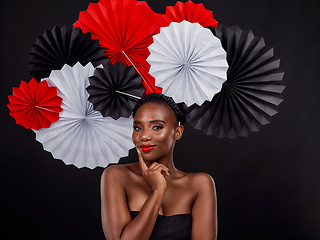 Image showing Beauty, portrait and black woman with origami fans in studio isolated on a dark background. Face, makeup cosmetics and skincare of female model with traditional Japanese paper art for culture hat.