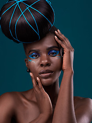 Image showing Portrait, hands and hair with a model black woman in studio on a blue background for beauty. Face, haircare and cosmetics with an attractive young female person touching her skin at the styling salon