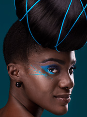 Image showing Portrait, hair and makeup with a black woman closeup in studio on a blue background for beauty. Face, haircare and cosmetics with an attractive young female model at the salon for fashion or styling