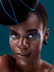 Image showing Portrait, makeup and eye shadow with a black woman in studio on a blue background for beauty. Face, hair and cosmetics with an attractive young female model at the salon for fashion or styling