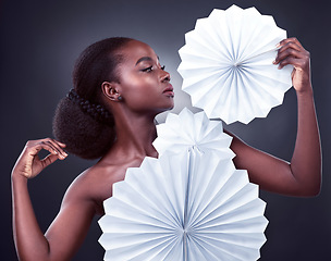 Image showing Beauty, fashion and black woman with origami, stylish and confident against a dark studio background. Female person, model or girl with trendy outfit, paper and glamour with elegant clothes and style