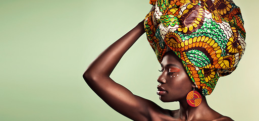 Image showing Makeup, fashion and black woman in head wrap in studio for culture, glow and cosmetics on green background with space. Beauty, skincare and african female model with pride, tradition and confidence