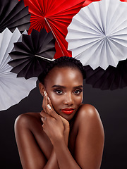 Image showing Portrait, beauty and black woman with origami fans in studio isolated on a dark background. Natural face, makeup cosmetics and skincare of female model with traditional Japanese paper art for culture