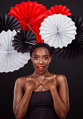 Image showing Portrait, surprise and black woman with origami fans, makeup and beauty against a black background. Face, female person and model with paper art, creative and announcement with fashion and creativity