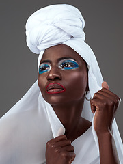 Image showing Art, culture and black woman with traditional clothes and makeup isolated on studio background. Fashion, looking away and an African model with creative cultural clothing and cosmetics for confidence