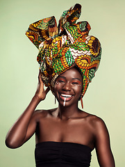 Image showing Beauty, black woman and portrait with African head scarf and smile in a studio. Isolated, green background traditional Africa wrap with a young female model with culture and pride with cosmetics