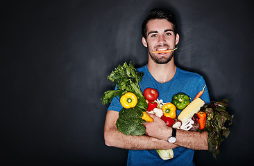 Image showing Healthy, portrait of young man with vegetables and in black background. Vegan lifestyle or nutrition, food for a diet and male person isolated in studio backdrop with groceries or ingredients