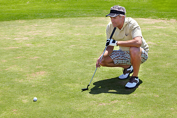 Image showing Golf, thinking and green with a sports man outdoor, playing a game for recreation on grass during summer. Planning, fitness and sport with a mature male golfer or athlete on a course for a match