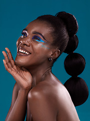 Image showing Thinking, happy and makeup with a model black woman in studio on a blue background for hair or cosmetics. Face, idea and fashion with an attractive young female person posing for cosmetic beauty