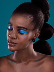 Image showing Face, beauty and makeup with a black woman closeup in studio on a blue background for hair or fashion. Eyes closed, cosmetics and haircare with an attractive young female model posing for haircare