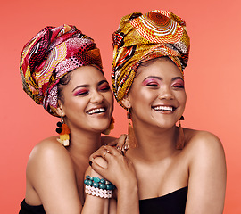 Image showing African fashion, friends and women laugh on orange background with cosmetics, makeup and accessories. Glamour, luxury and face of female people with exotic jewelry, traditional style and head scarf