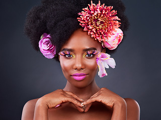 Image showing Makeup, flowers and portrait of black woman in studio for beauty, creative and spring. Natural, cosmetics and floral with african model isolated on black background for color, self love or confidence