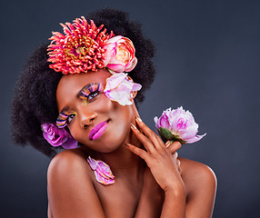 Image showing Beauty, flowers and black woman in studio for makeup, creative and organic on black background. Floral, body care and african female model pose with eco friendly, natural and cosmetics with mockup