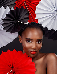 Image showing Portrait, makeup and black woman with origami fans, beauty and confident girl against black background. Face, female person or model with paper art, artistic and creativity with cosmetics and fantasy