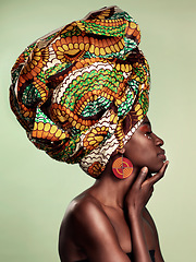 Image showing Beauty, profile and black woman in head wrap in studio for culture, glow and cosmetics on green background with space. Makeup, turban and african female model with pride, tradition and confidence