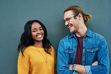 Image showing Love, portrait and happy couple laughing against a wall background, bonding and having fun. Interracial relationship, smile and african woman with man outdoors relax and enjoying date or conversation