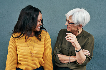 Image showing Senior businesswoman, break and conversation with employee, friend or colleague in discussion outside work on blue background. Women, talking and happy together or black woman, mature person smile