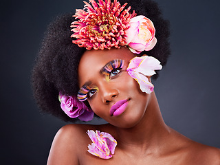 Image showing Makeup, flowers and face of black woman in studio for beauty, creative and spring. Natural, cosmetics and floral with african model isolated on background for art, self love or confidence