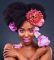 Image showing Makeup, portrait and black woman with flowers in studio for natural cosmetics on dark background. Floral, face and African female model pose with eco friendly, beauty and care on isolated color