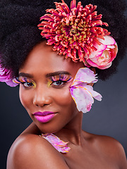 Image showing Makeup, flowers and art with portrait of black woman for beauty, creative and spring. Natural, cosmetics and floral with face of model isolated on studio background for color, self love or confidence