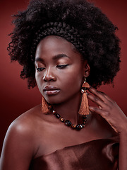 Image showing Beauty, natural skin and black woman in studio with glow on gradient, maroon or red background. Face, makeup and African lady model with culture, pride or cosmetic, isolated or style and aesthetic